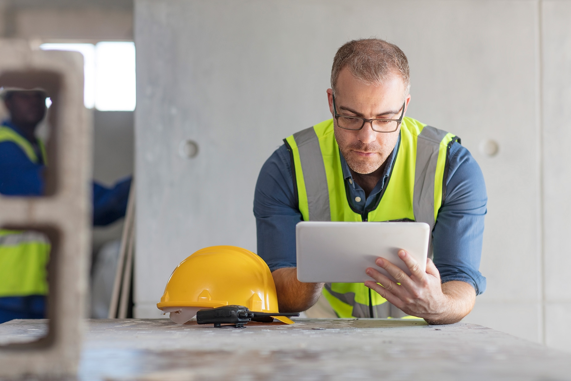 Construction supervisor reviewing project information on a tablet